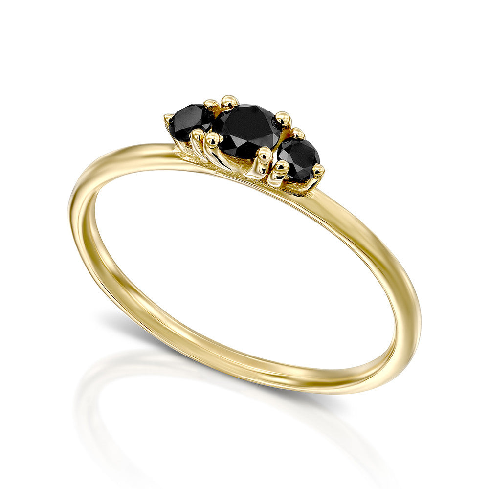 A fine gold ring set with three black diamonds