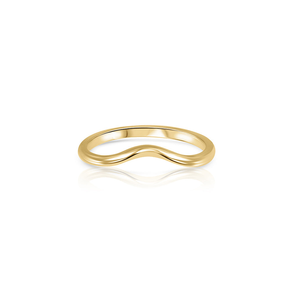 A gold wedding ring in the shape of a wave - a complementary ring