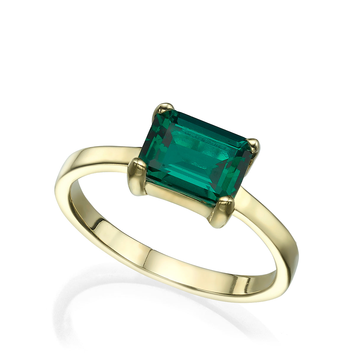 Gold ring inlaid with lab emeralds in a rectangular cut