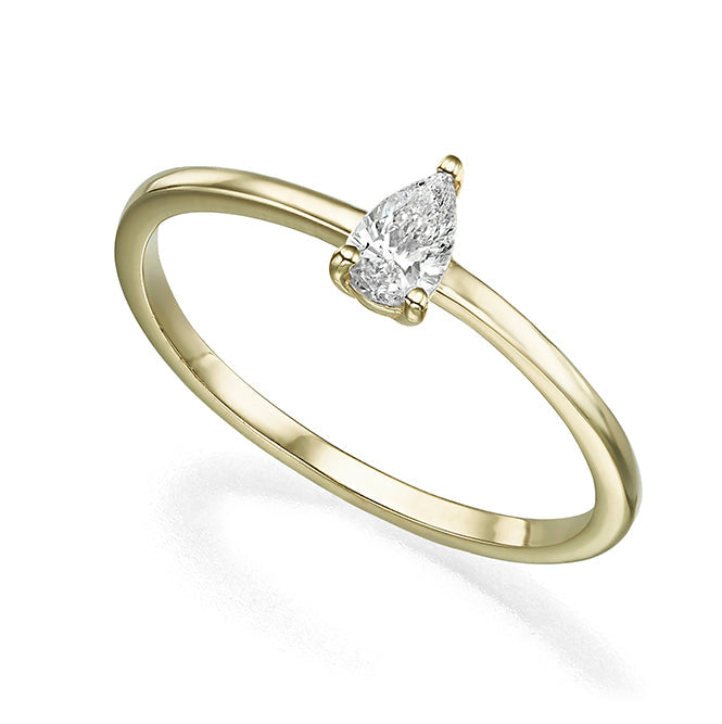 A delicate solitaire ring set with a drop-cut diamond