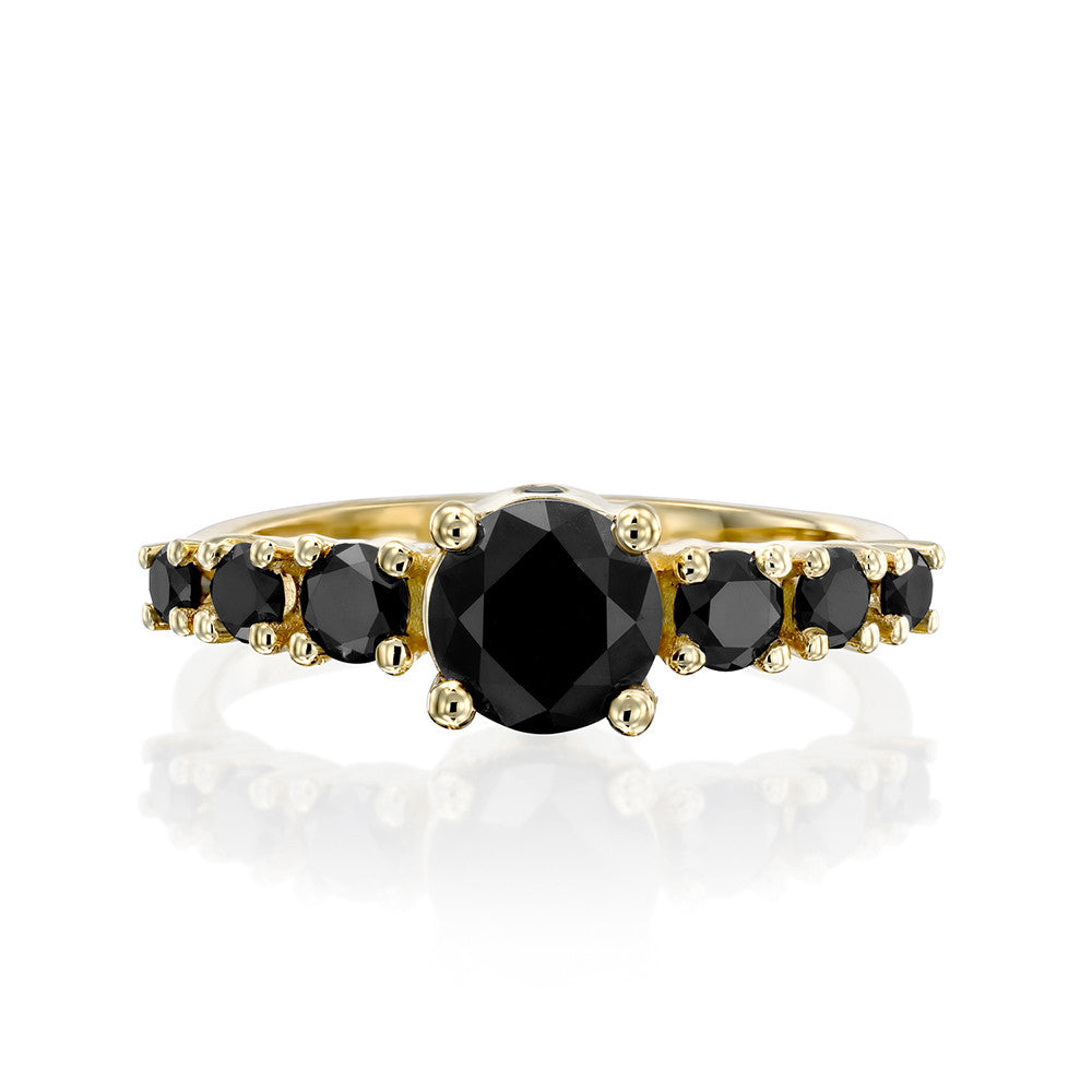 A black diamond ring for a woman set with a 1 carat central diamond and 6 side black diamonds