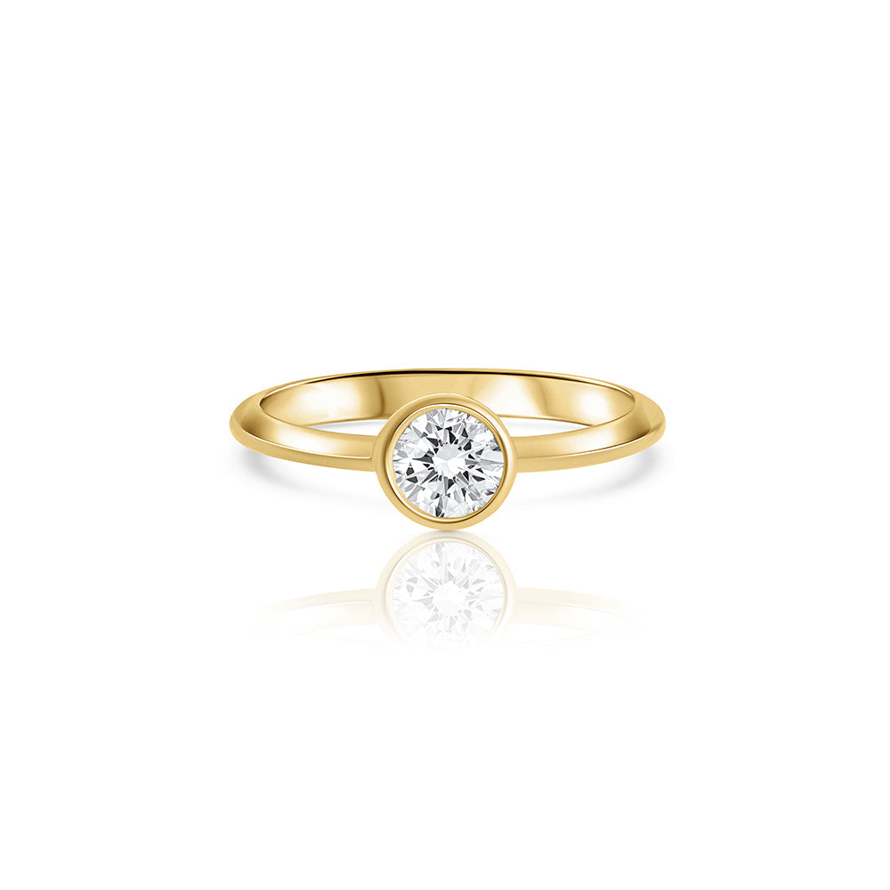 A solitaire ring set with a half carat laboratory diamond in a gold frame.
