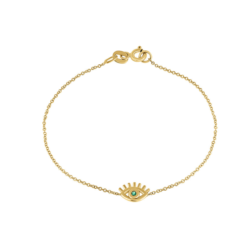 Modern fine gold eyelash bracelet with an emerald in the center