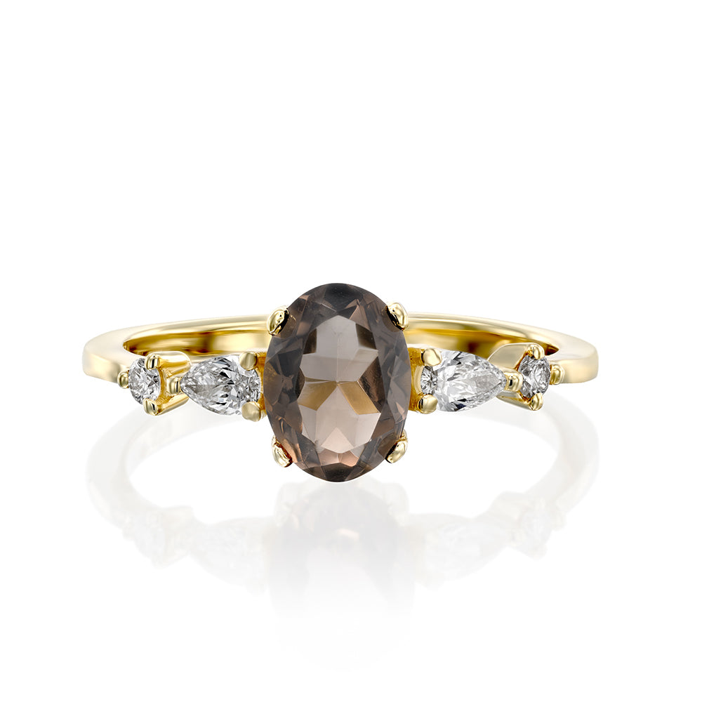 A gold ring set with smoky quartz and drop and round cut diamonds