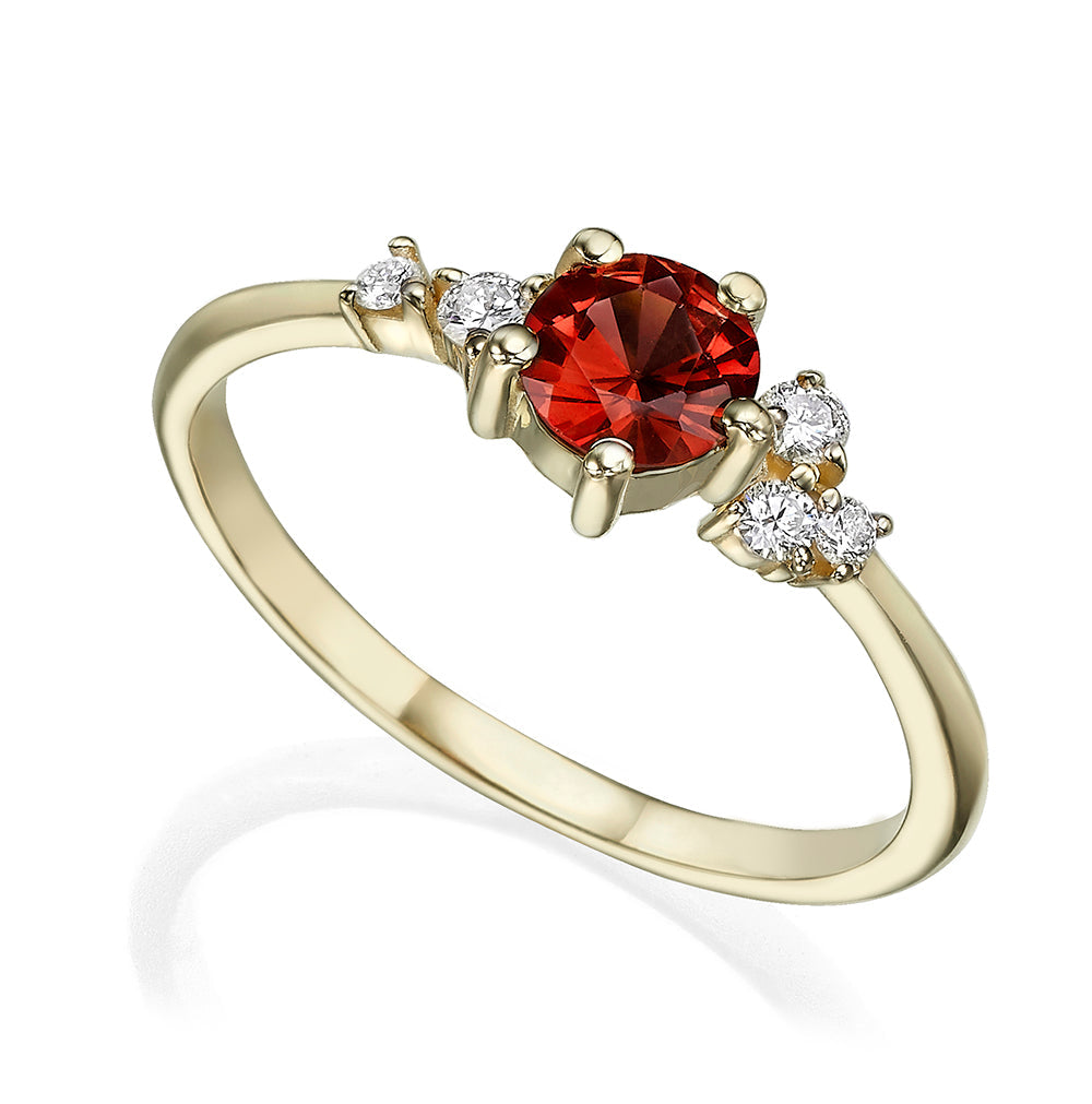 An engagement ring set with rhodolite and small one-centimeter diamonds