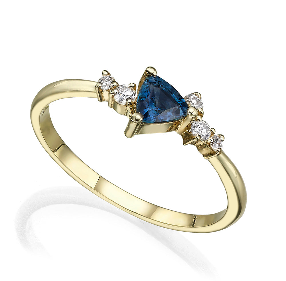An engagement ring set with a trillion-cut sapphire and diamonds all around