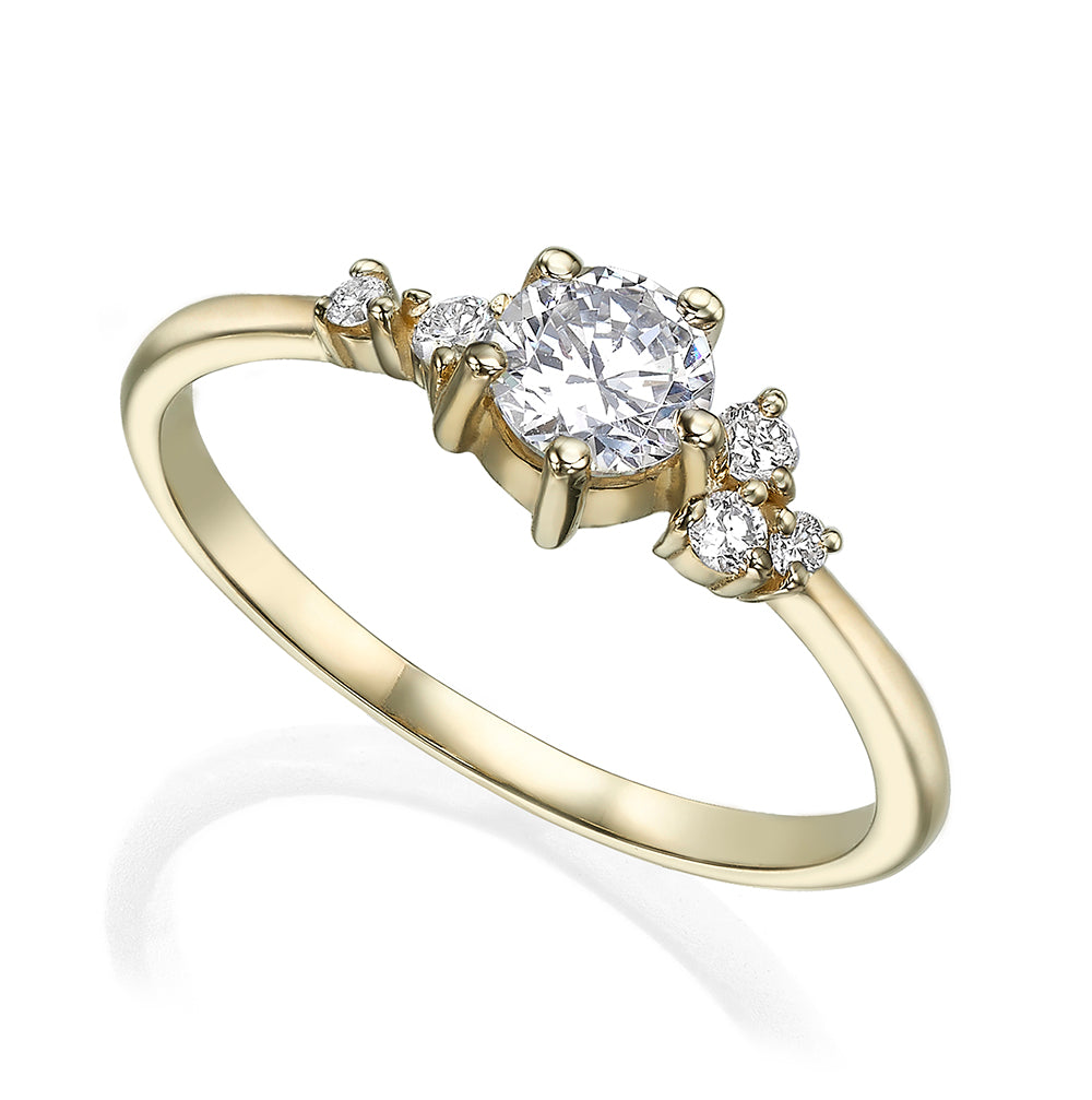 An engagement ring set with a half carat diamond and small asymmetric diamonds