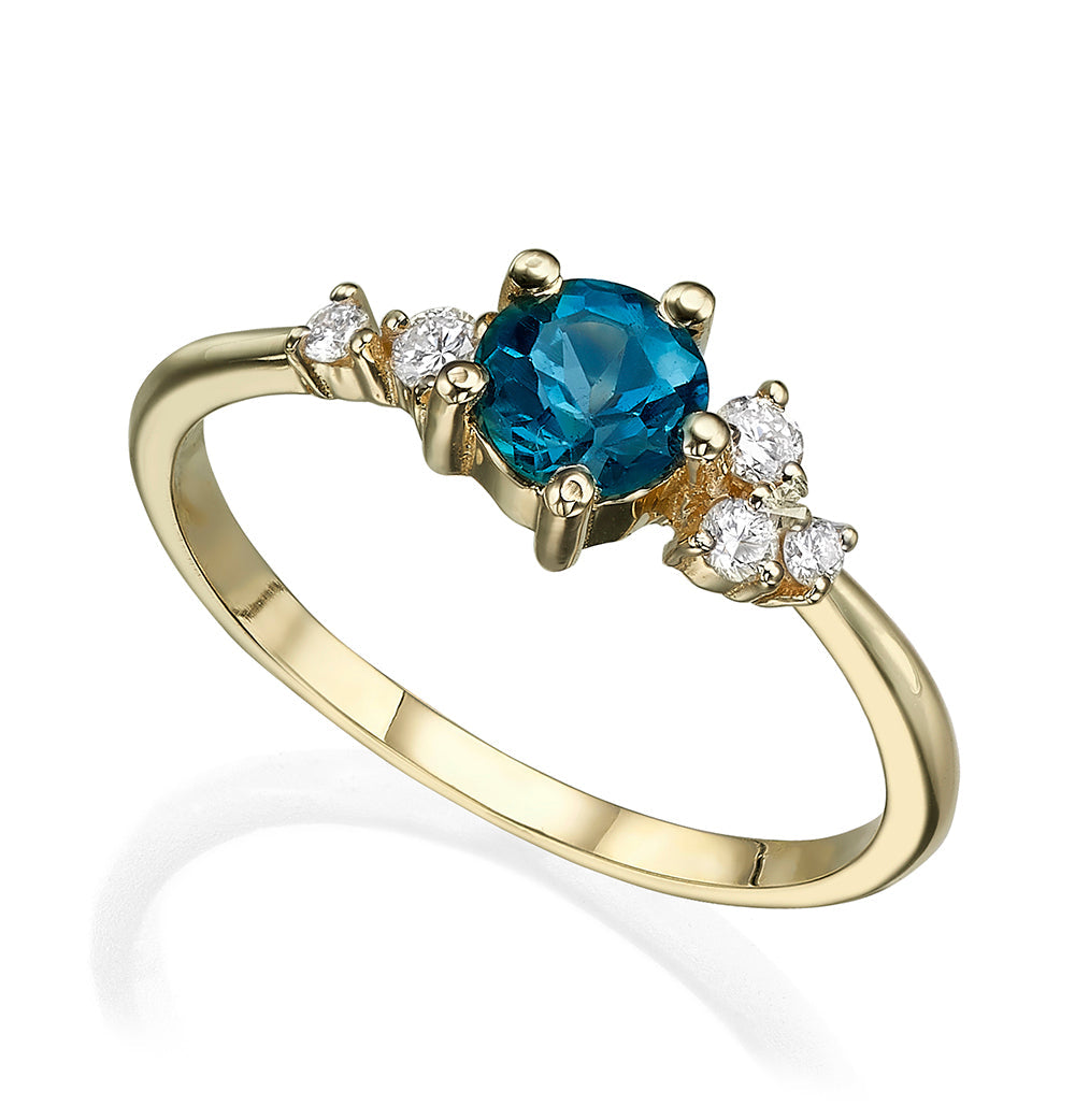 An engagement ring set with London blue topaz and small one-centimeter diamonds