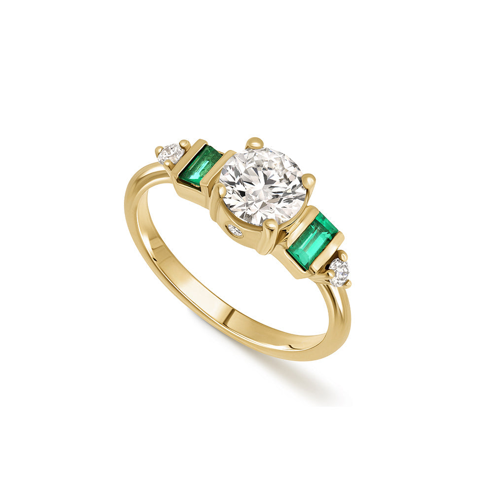 An engagement ring in gold and laboratory diamonds in a unique design of round diamonds and emeralds