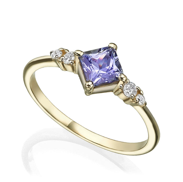 A gold ring set with princess-cut tanzanite and diamonds on the sides