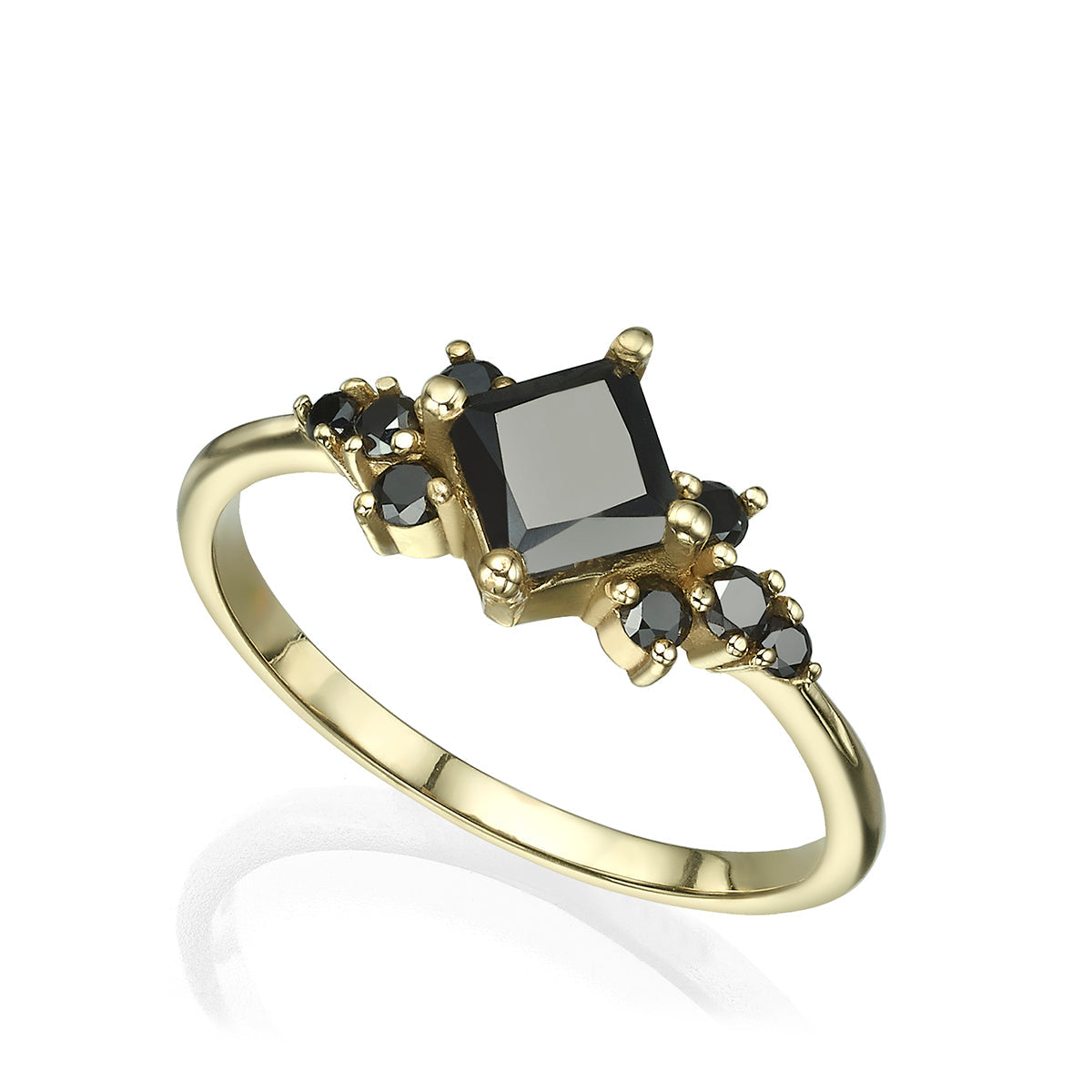 A gold ring set with a princess-cut black diamond and round black diamonds