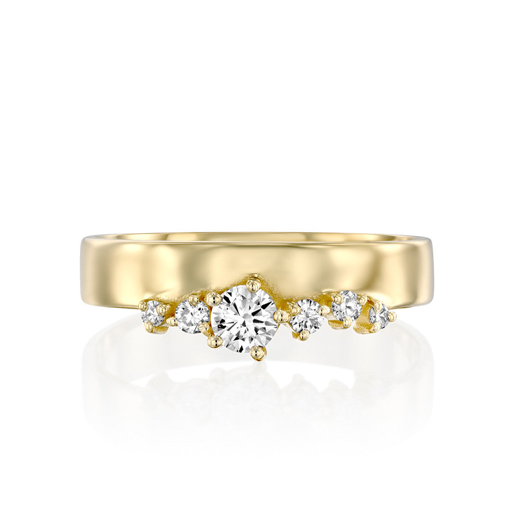 A wide gold ring with a special asymmetric setting of diamonds