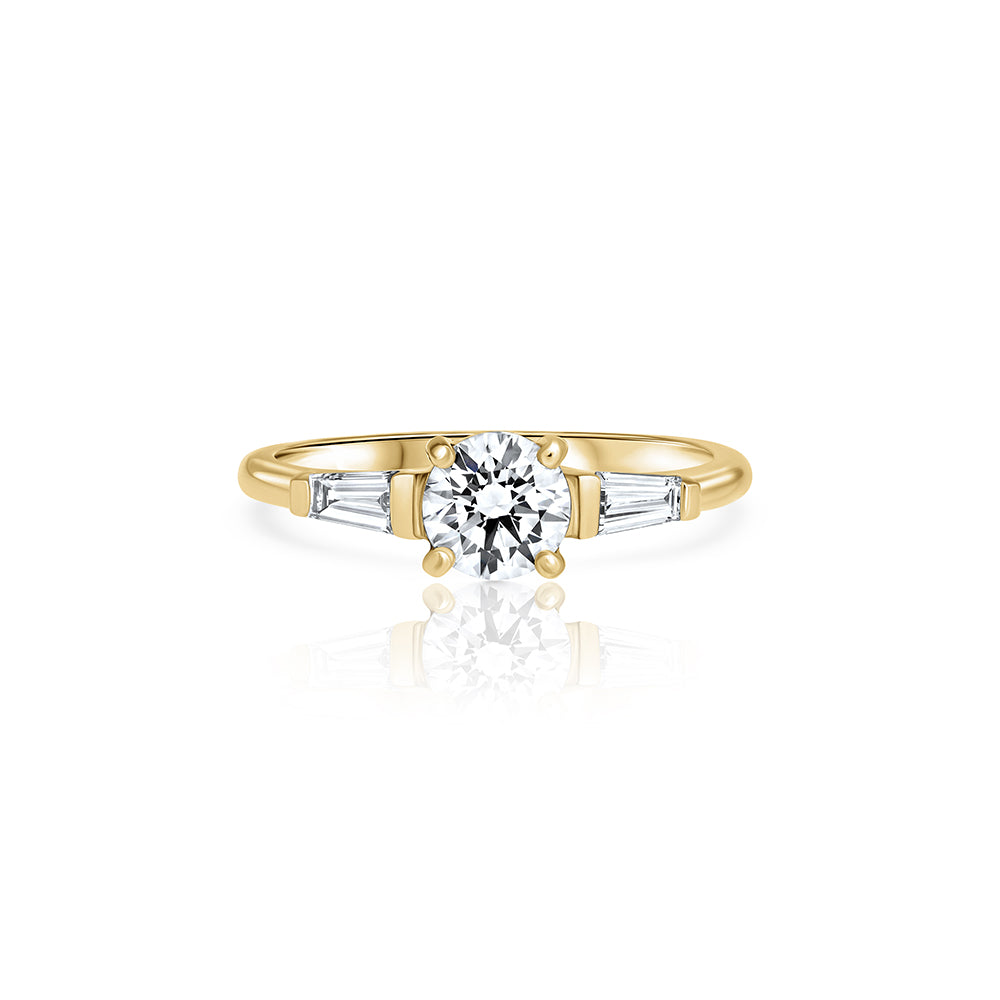 Engagement ring set with lab diamonds, a central round lab diamond, 0.70ct and two taper cut lab diamonds