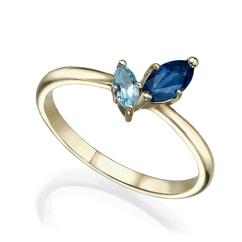 A special gold ring inlaid with sapphire and blue topaz in the shape of a marquise