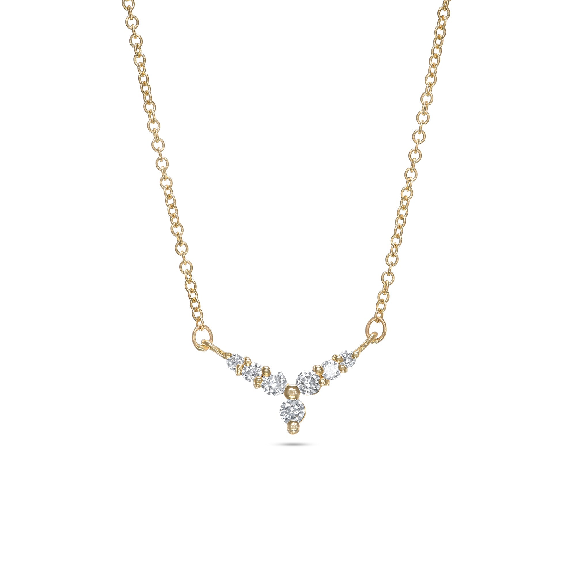 A gold necklace with a V-shaped pendant studded with diamonds reminiscent of a flower