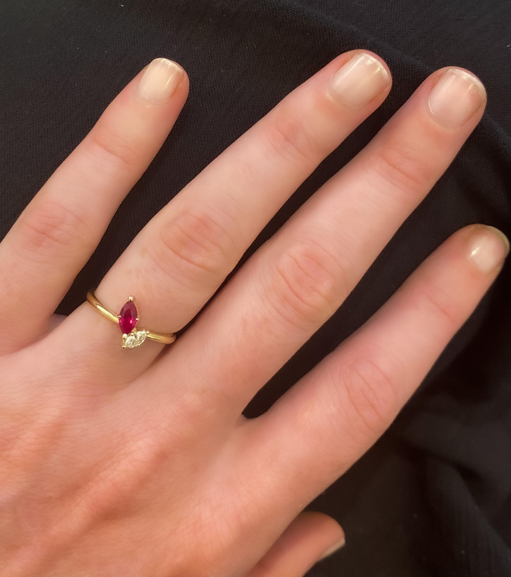 A special gold ring set with a diamond and sapphire in the shape of a marquise