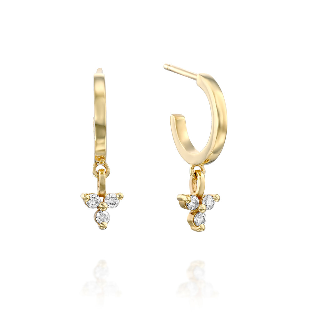 Gold hoop earrings with a triangular pendant with 3 white diamonds