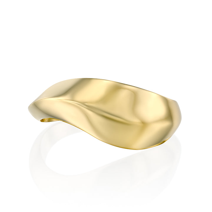 A wide geometric gold ring in a wave shape