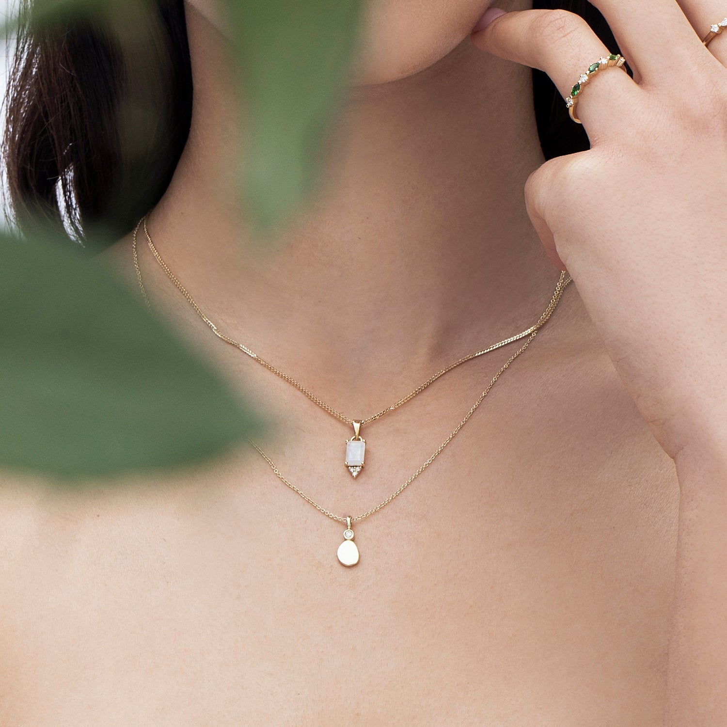 Gold necklace with moonstone inlaid pendant in emerald cut and diamonds