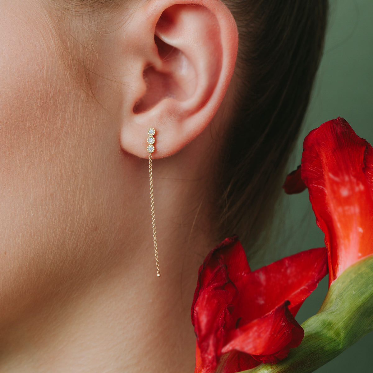 Attached white diamond earrings with a gold chain