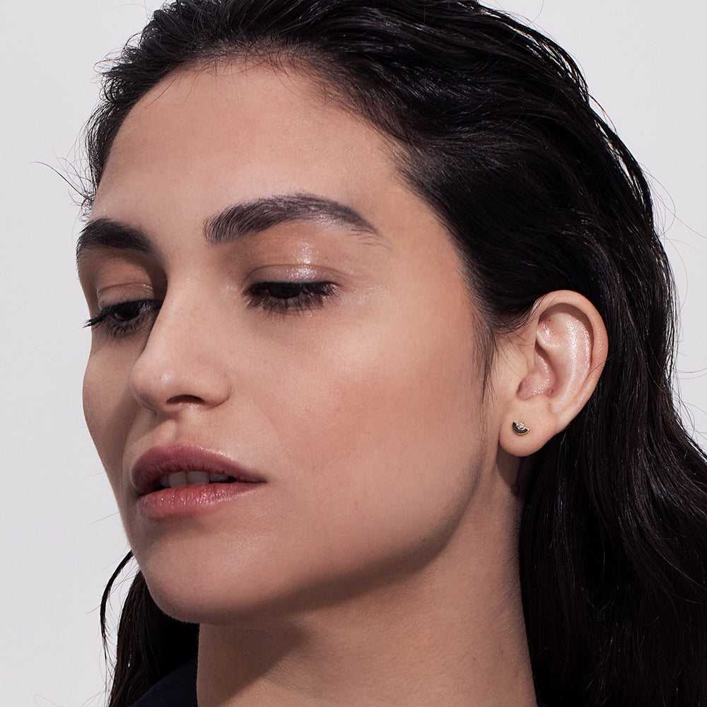 Gold earrings, tight, small, in the shape of a semicircle, set with a diamond