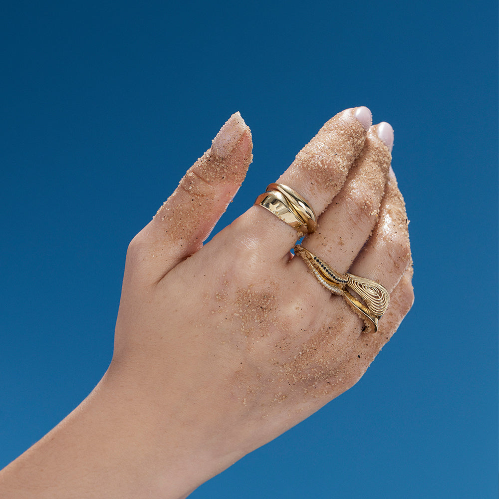 A thick geometric wave-shaped gold ring