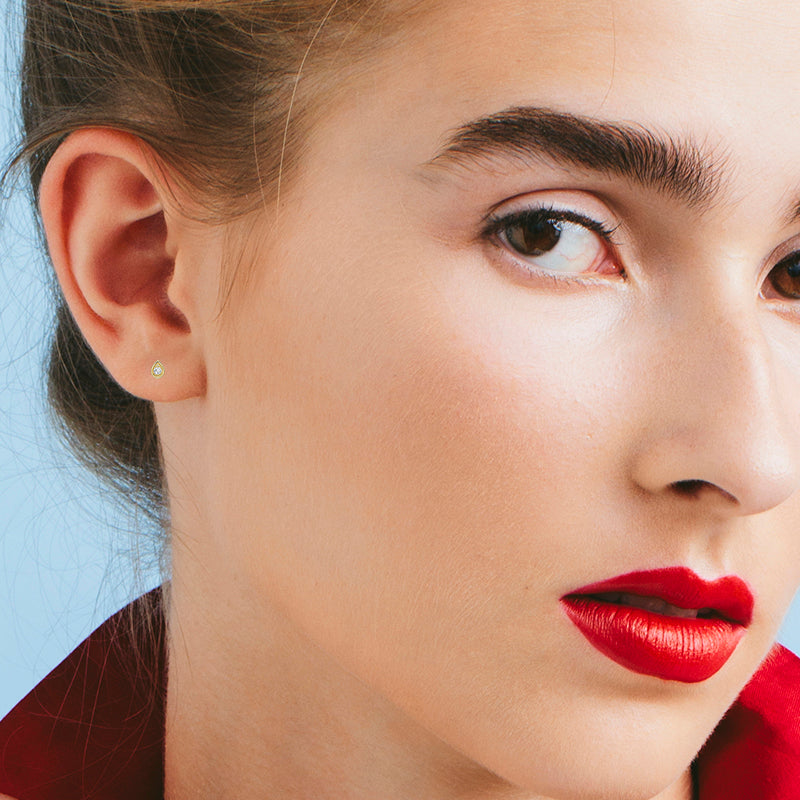 Small attached round diamond earrings in a drop frame