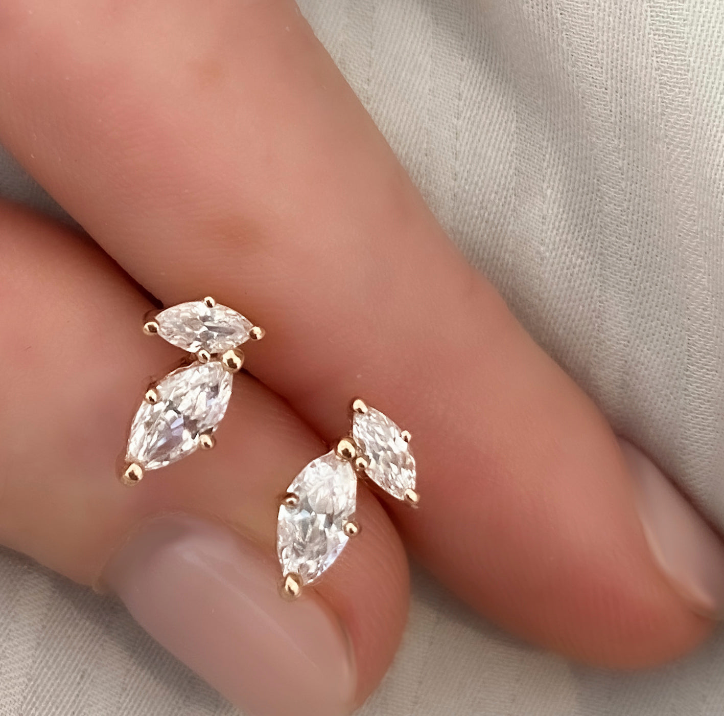 Tight gold earrings set with marquise-cut laboratory diamonds