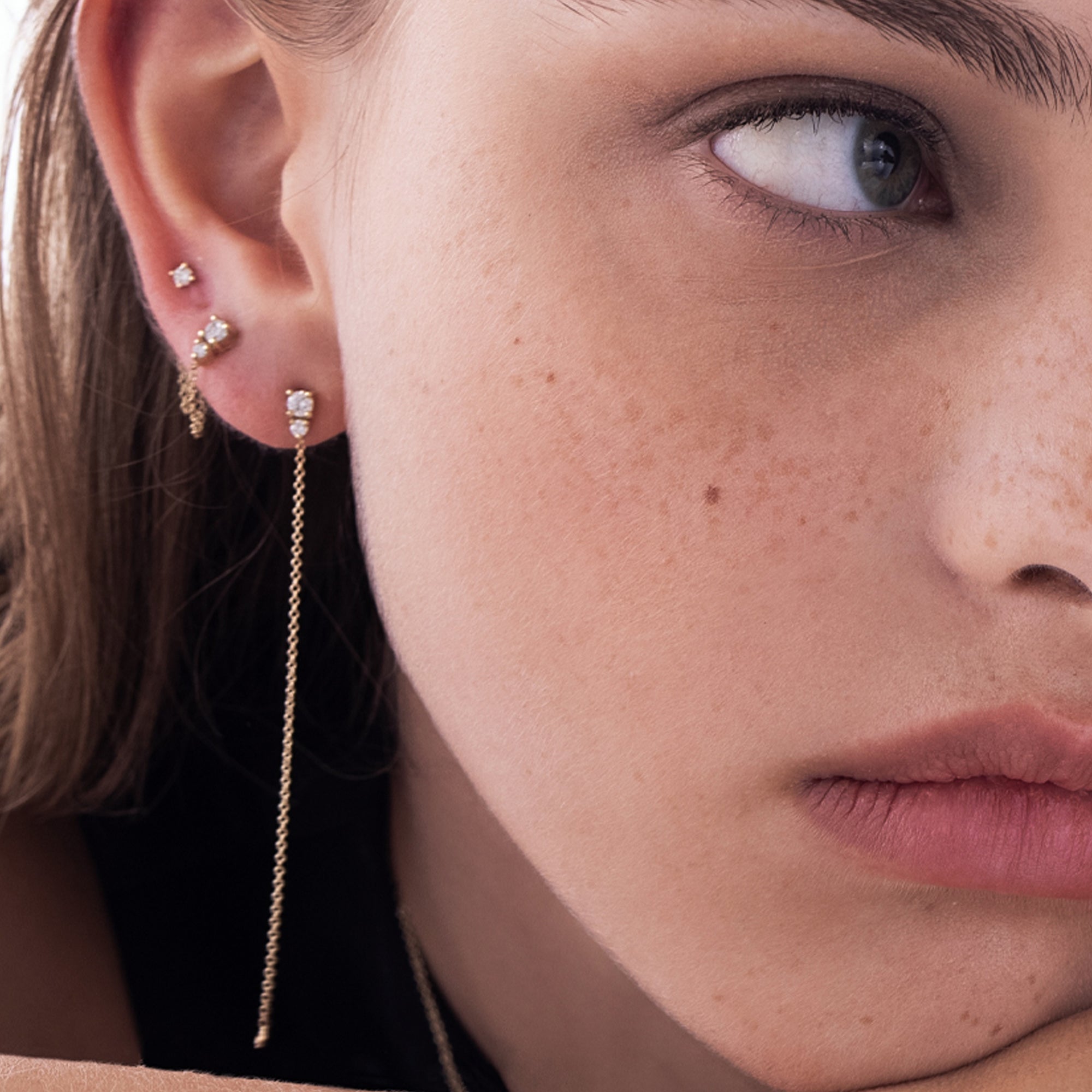 A special gold chain earring studded with laboratory diamonds