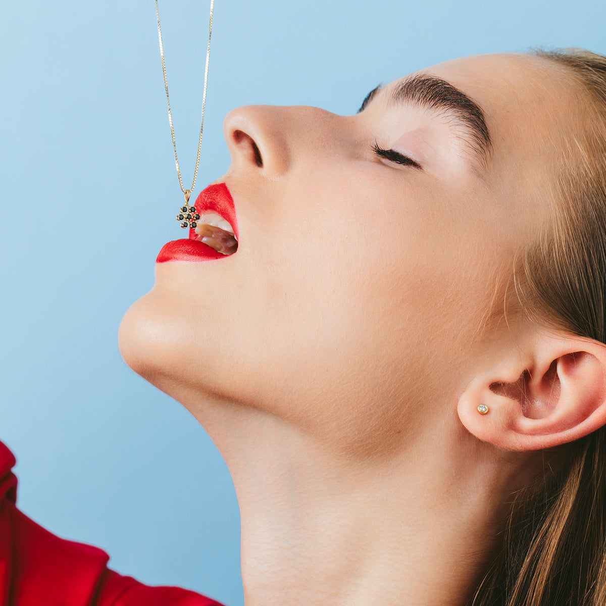 Gold chain and snowflake pendant studded with black diamonds