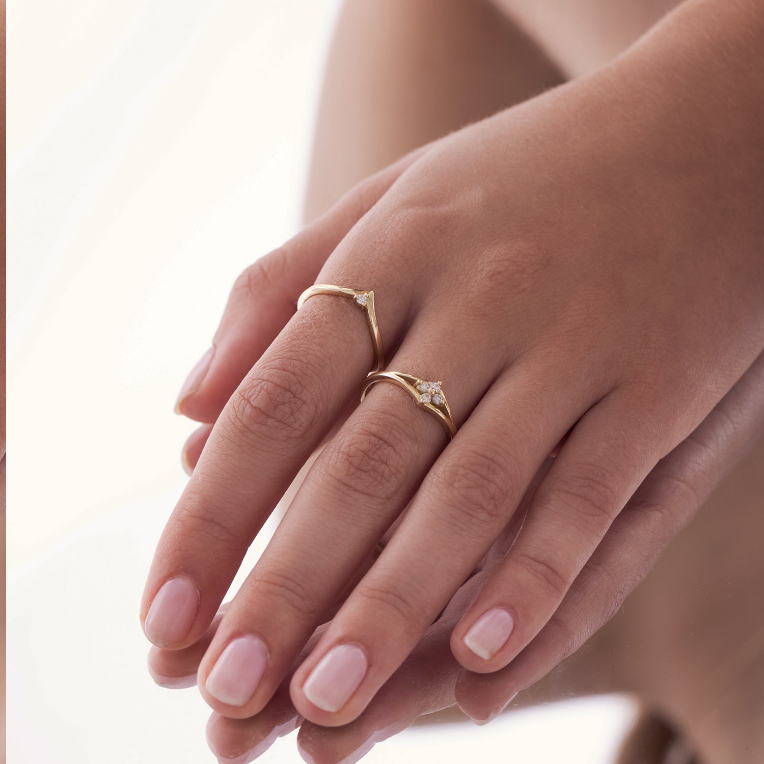 V-shaped gold ring set with a white diamond