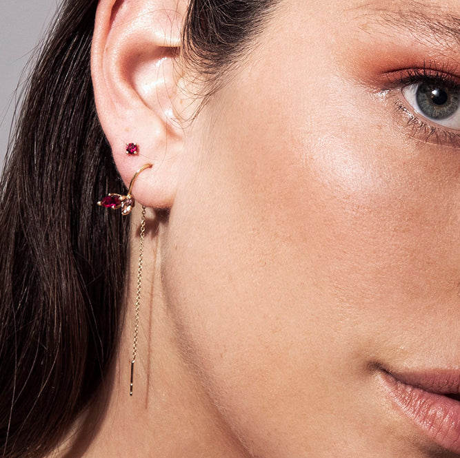 Gold solitaire earrings studded with ruby stones