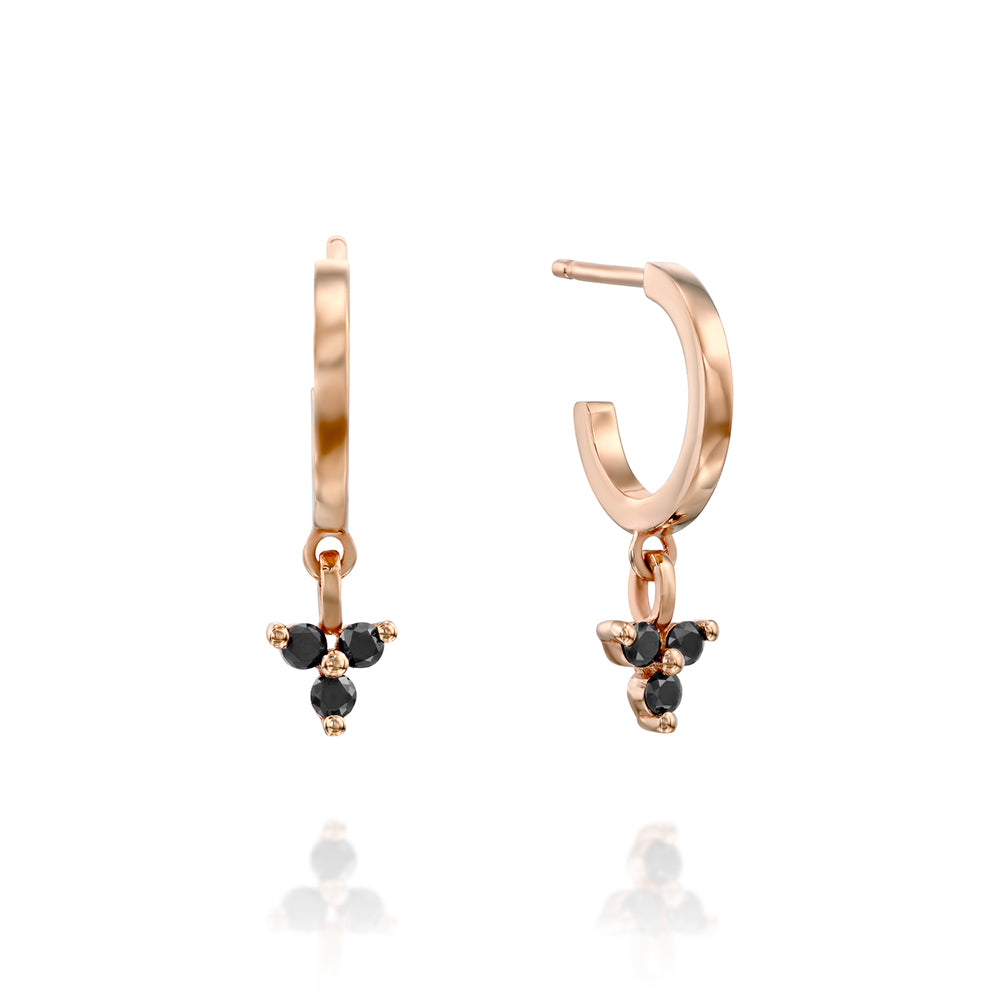 Gold hoop earrings with a pendant studded with 3 black diamonds
