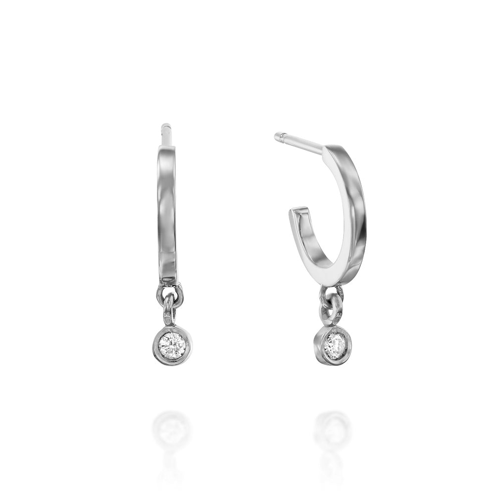 Small gold hoop earrings with a 4-point diamond pendant in a gold frame
