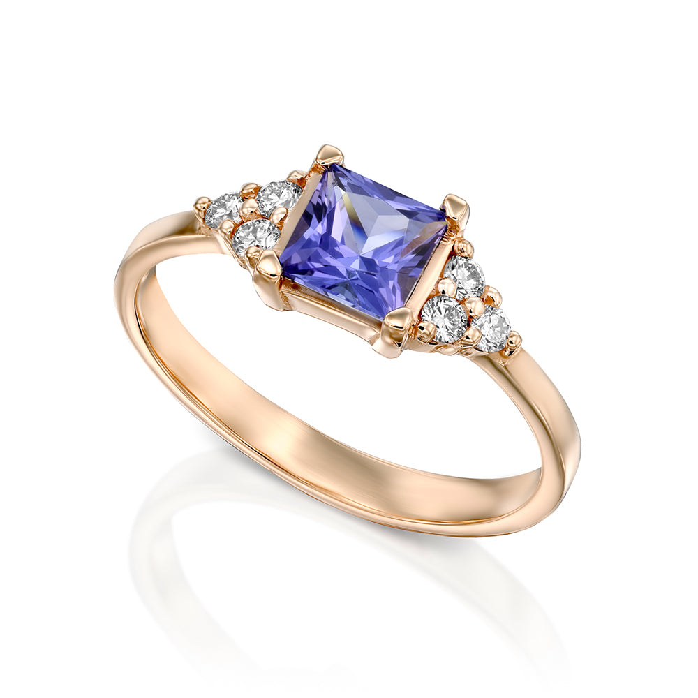 A gold ring set with Tanzanite Princess and 6 sided diamonds