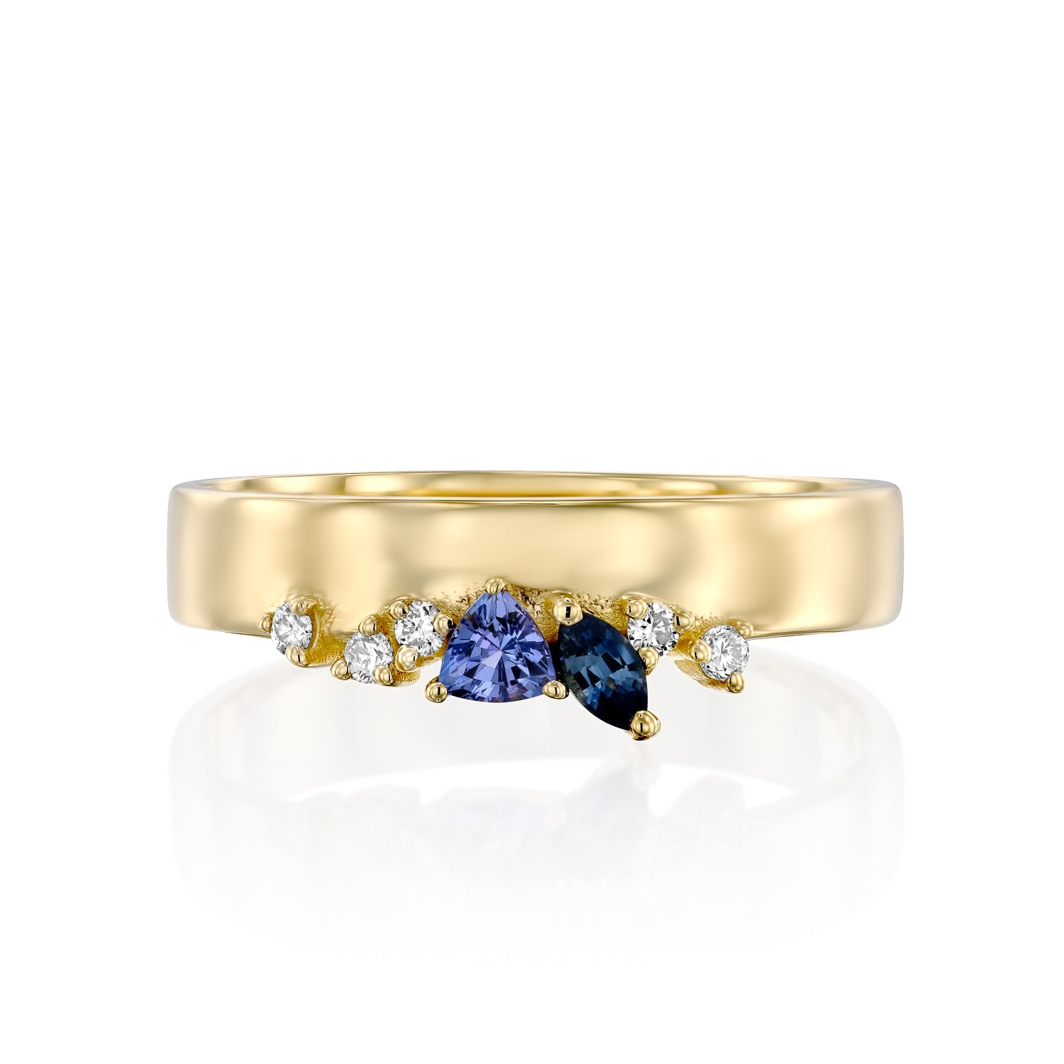 A wide gold ring with a special asymmetric setting of tanzanite, sapphire and diamonds