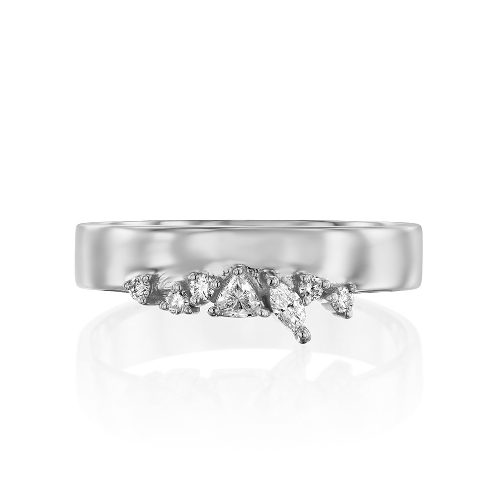 A wide gold ring with a special asymmetric setting of diamonds in a variety of cuts
