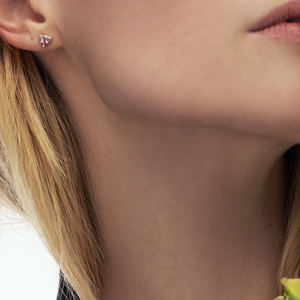 Gold studded gold earrings set with trillion-cut champagne garnet