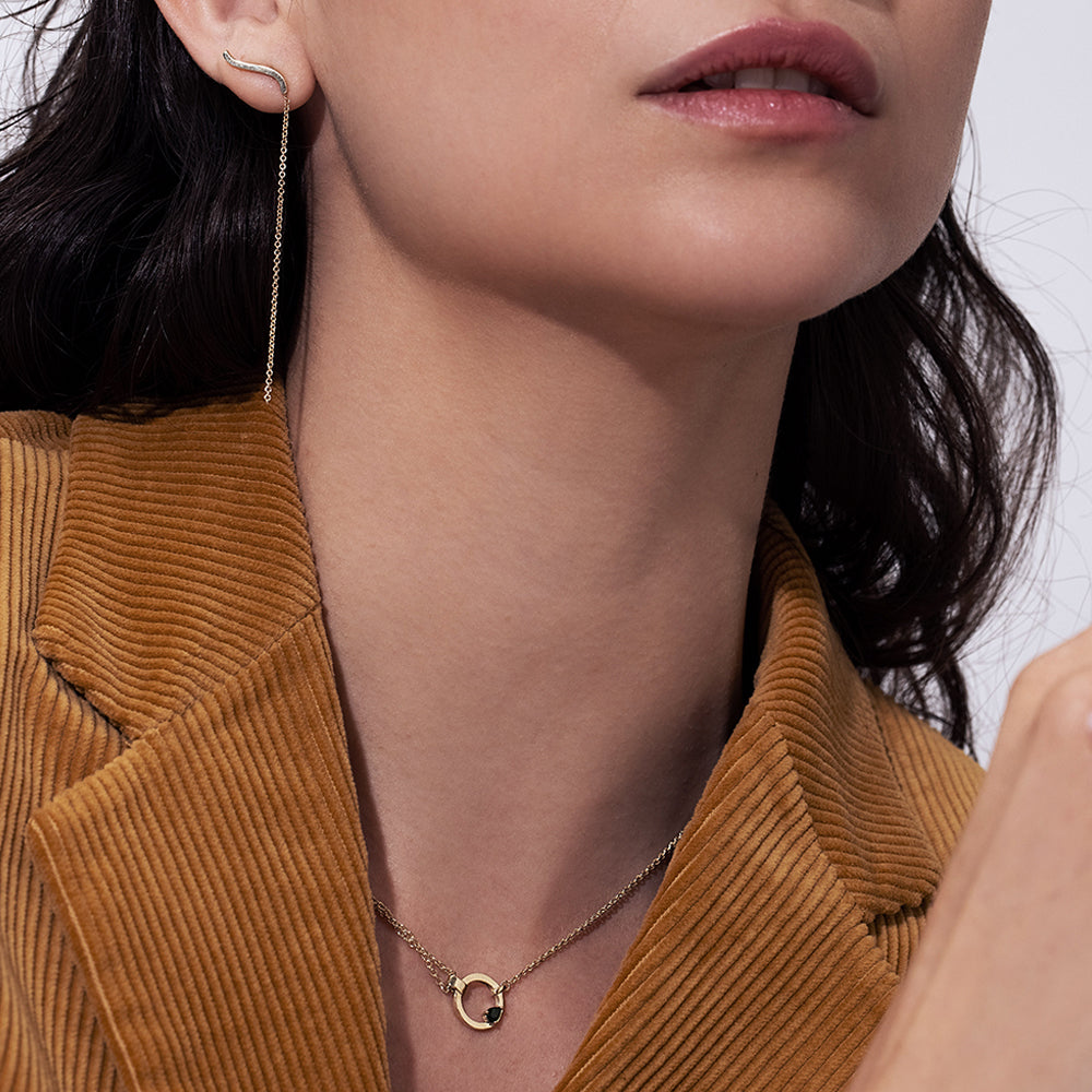 A thick, asymmetric and special gold chain, with a modern and impressive design. Set with tourmaline and diamond