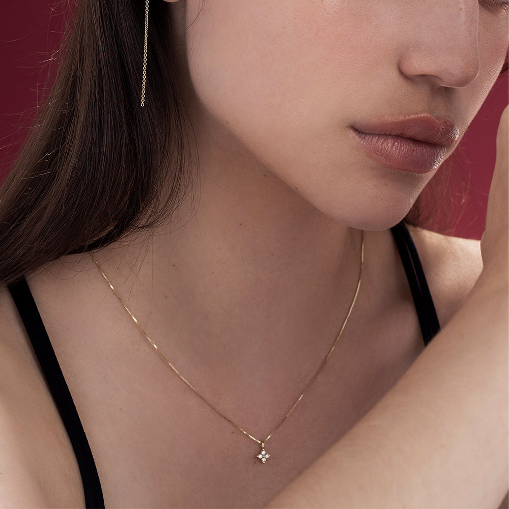Fine gold necklace with a flower pendant inlaid with 4 diamonds