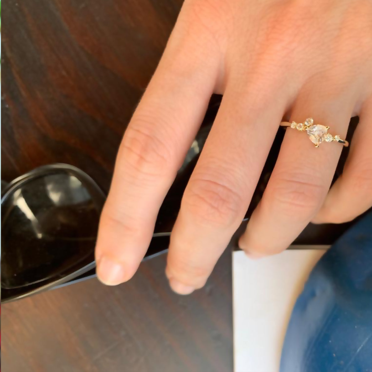 An engagement ring set with a trillion-cut diamond and diamonds all around