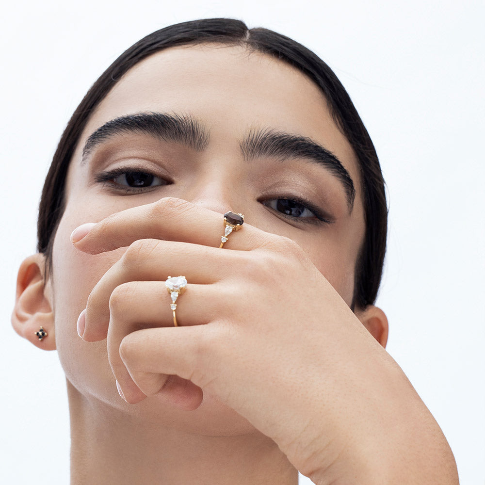 A gold ring set with smoky quartz and drop and round cut diamonds