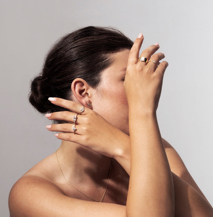 An engagement ring set with a central drop-cut diamond and triangular-cut diamonds on the sides