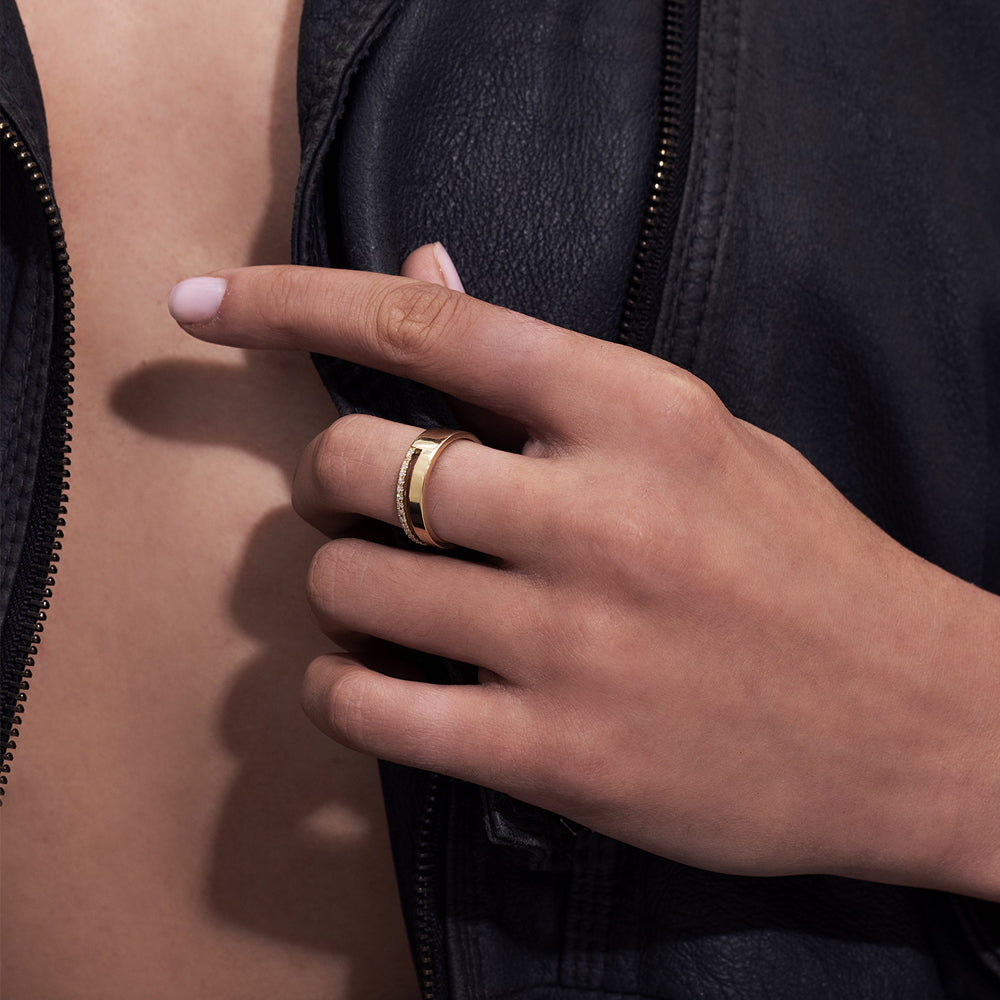 A double gold ring set with a row of diamonds and a smooth wide band