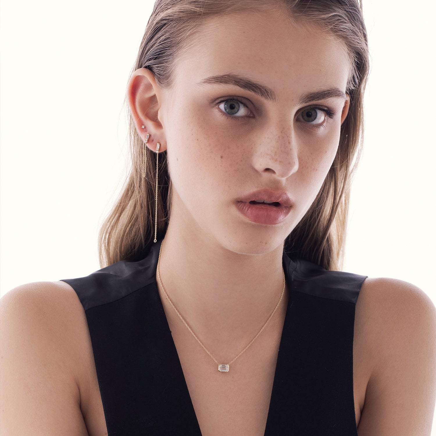 A classic gold necklace set with a 1 carat emerald cut lab diamond