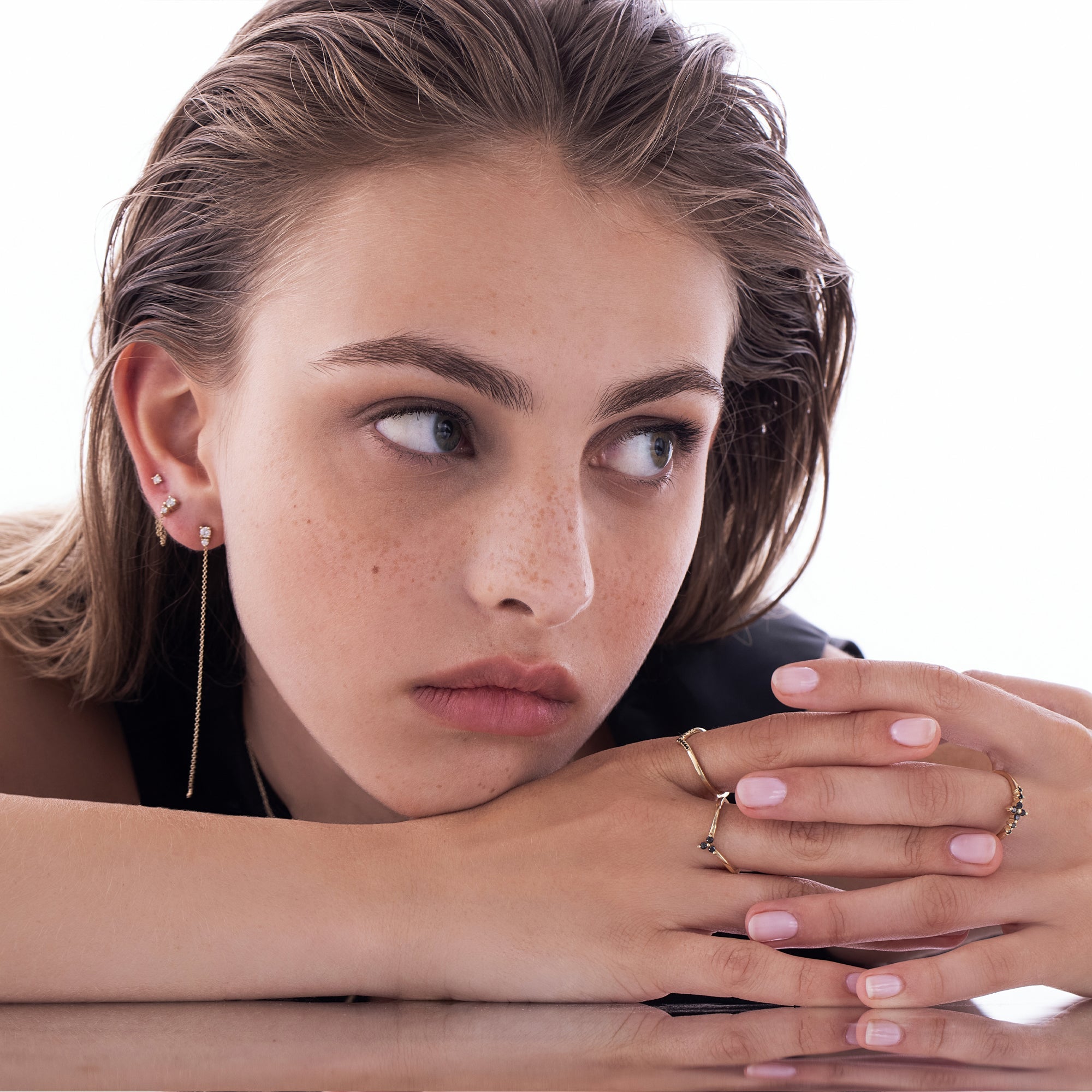 V-shaped gold ring set with 3 black diamonds