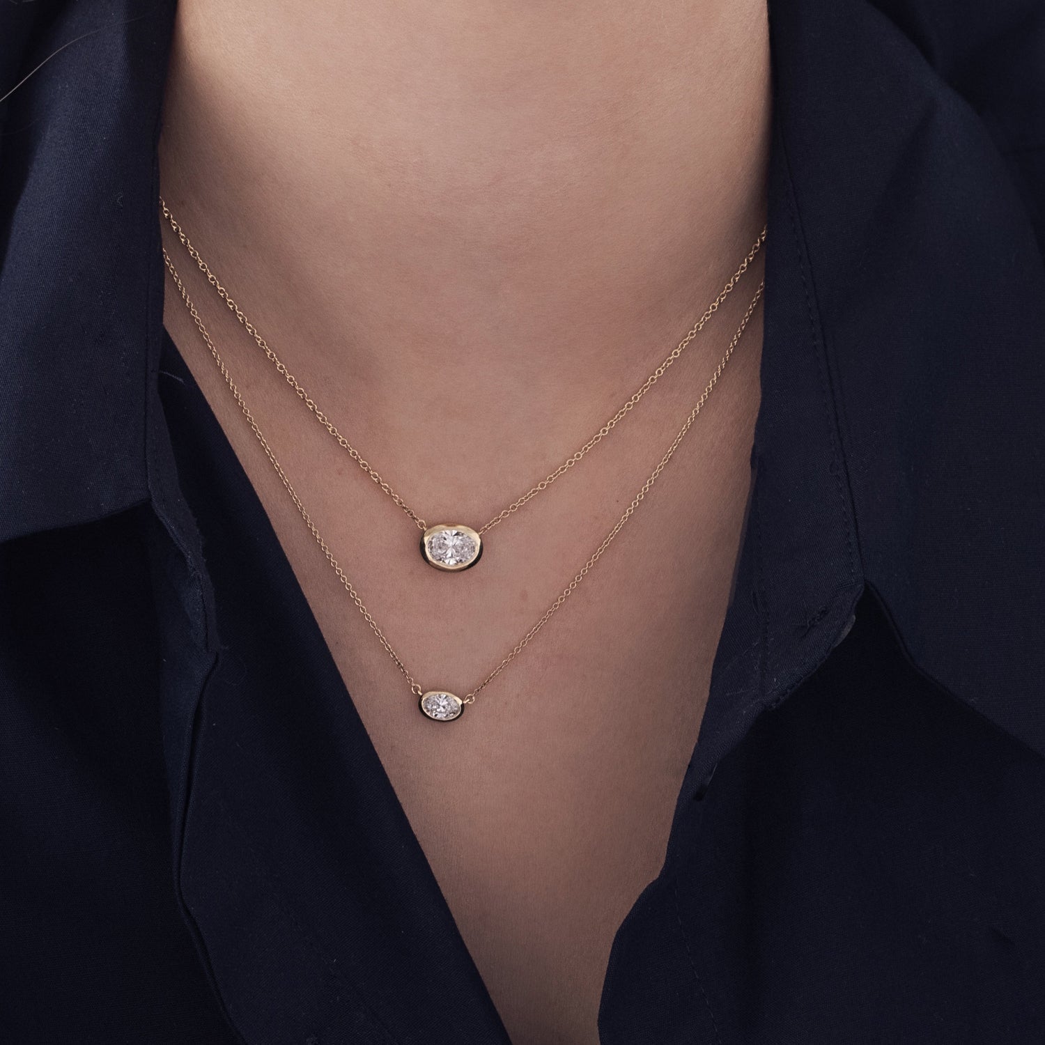 A classic gold necklace set with an oval-cut lab diamond