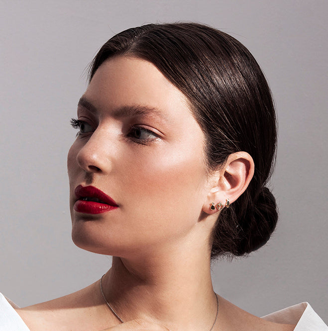 Gold attached earrings with diamonds in an amorphous point design