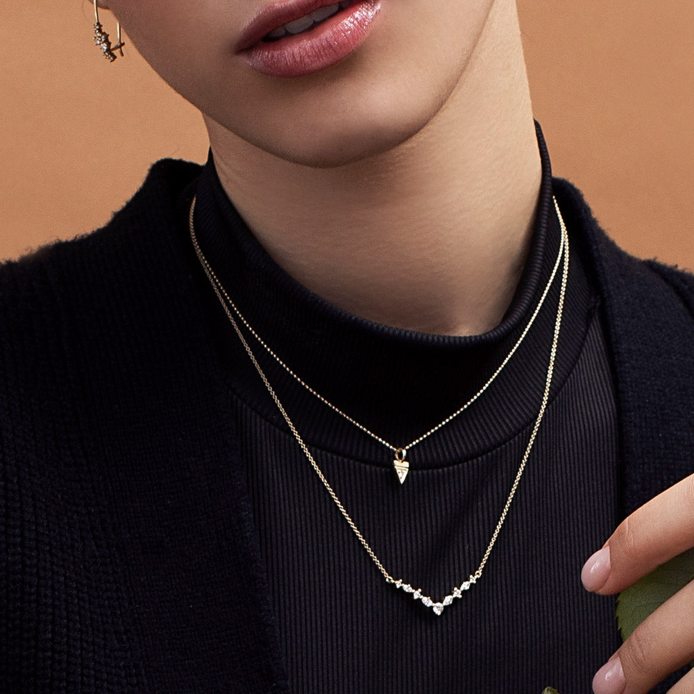 Fine gold chain with a triangle-shaped pendant studded with a 3-point diamond