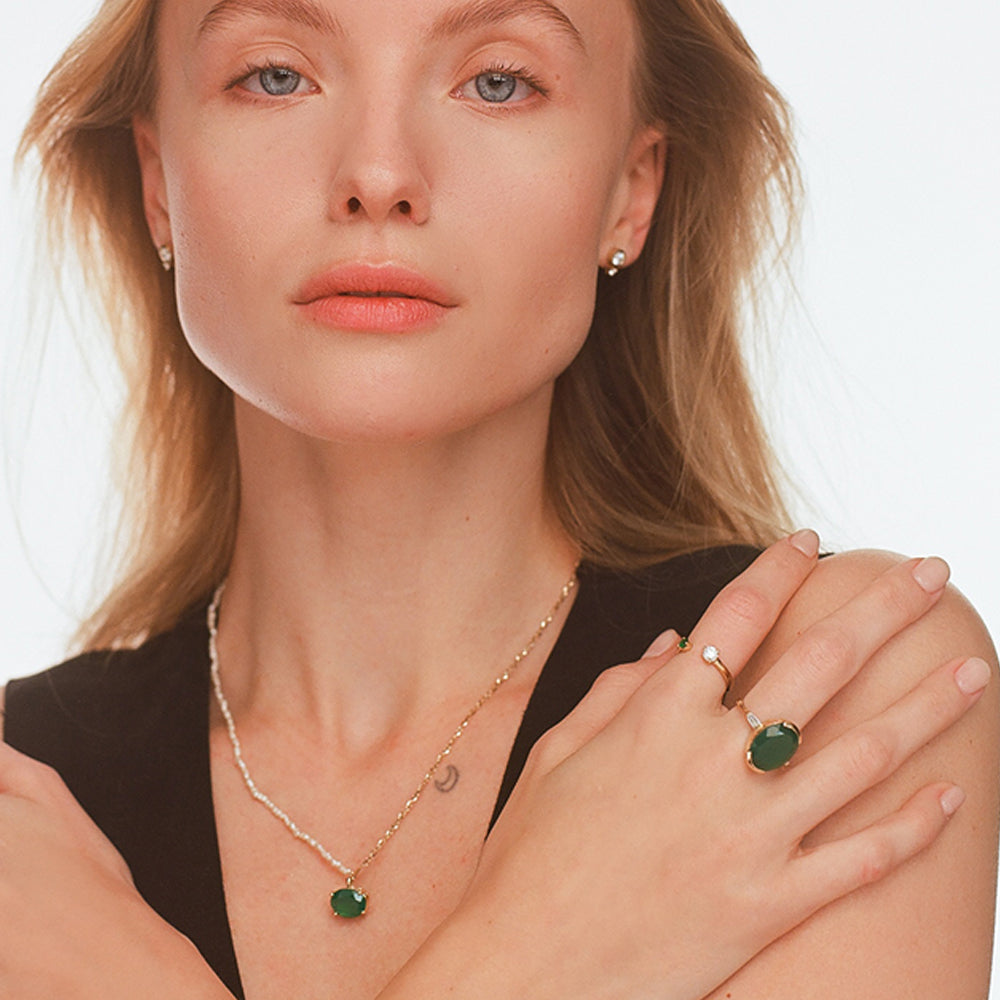 An impressive green onyx ring with an oval cut and laboratory diamonds